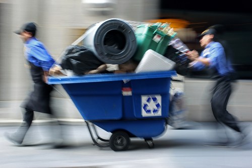 Crew carrying office furniture from a terraced building